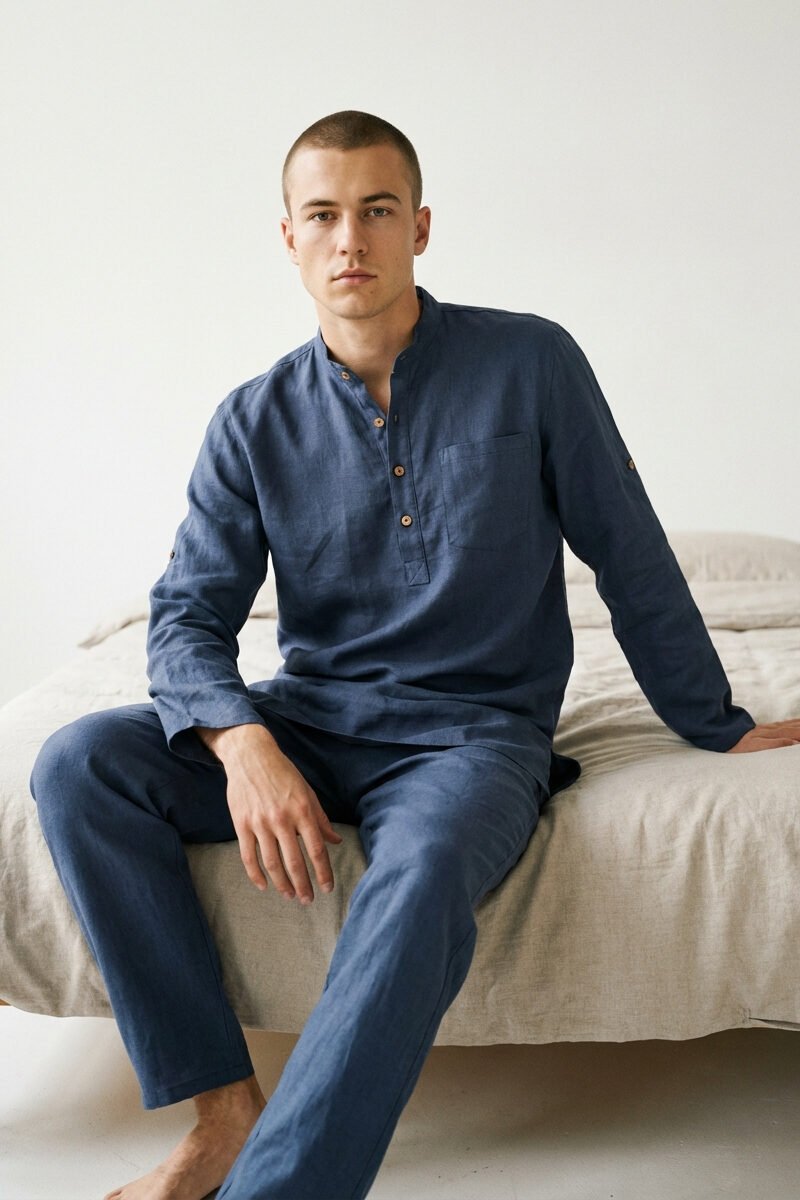 Men’s loose-fit linen tunic in blue, featuring a minimalist design with long sleeves and side slits, styled casually over pants for a relaxed, breathable look.