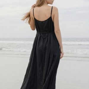 Model wearing black linen cami dress Lila on the beach